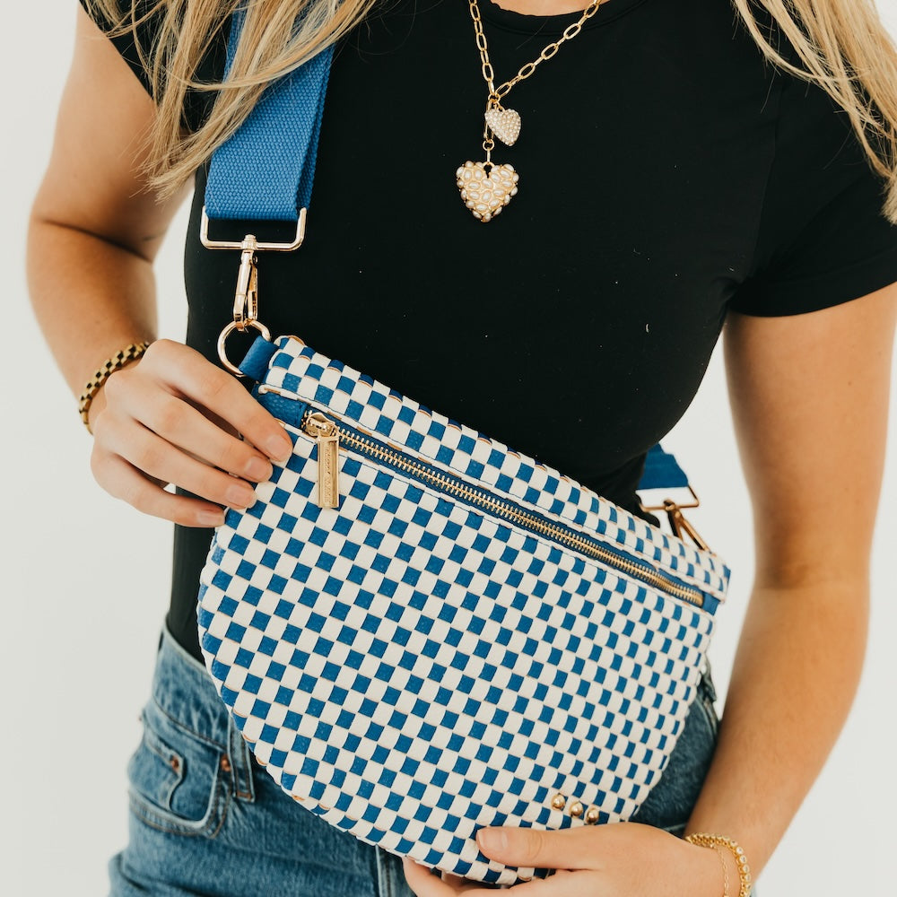 Blue and white woven checkered bum bag with zipper top and adjustable crossbody strap.