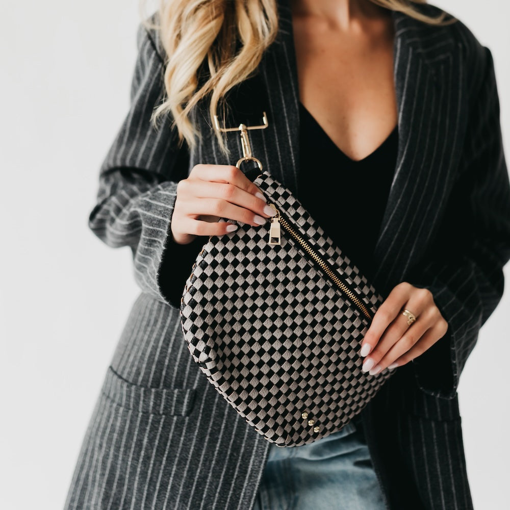 Westlyn woven bum bag in black-and-white checker pattern, metal top handle and zipper