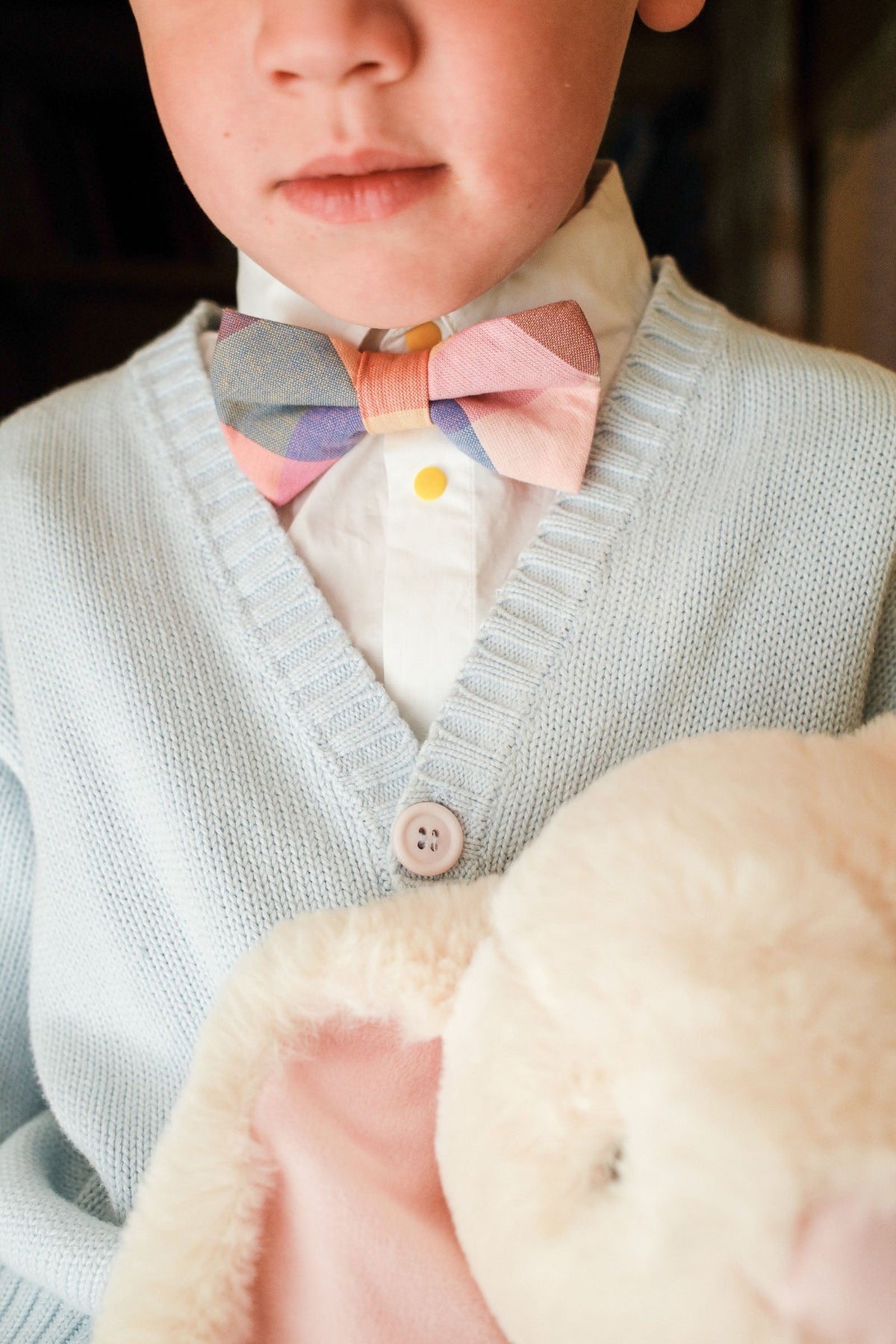 Plaid bow tie on boy’s collar, pastel multicolor check design