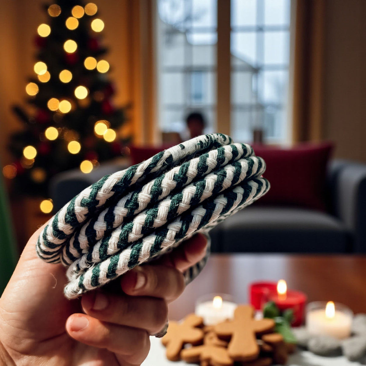 Candy cane coaster held in hand, green and cream spiral rope circle