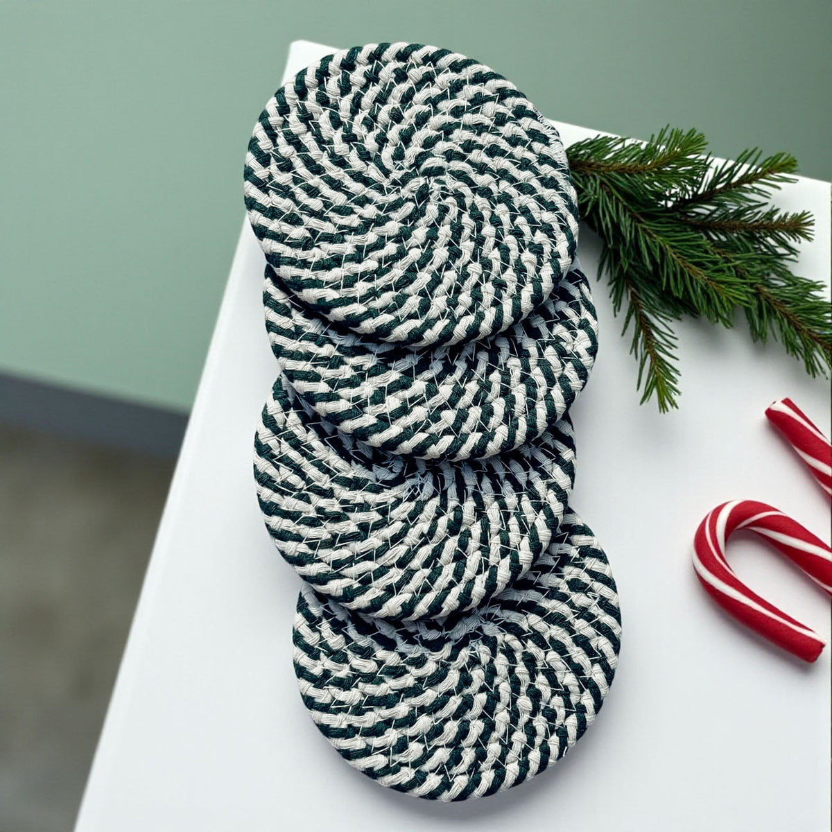 Stack of round woven coasters with navy-and-white striped pattern