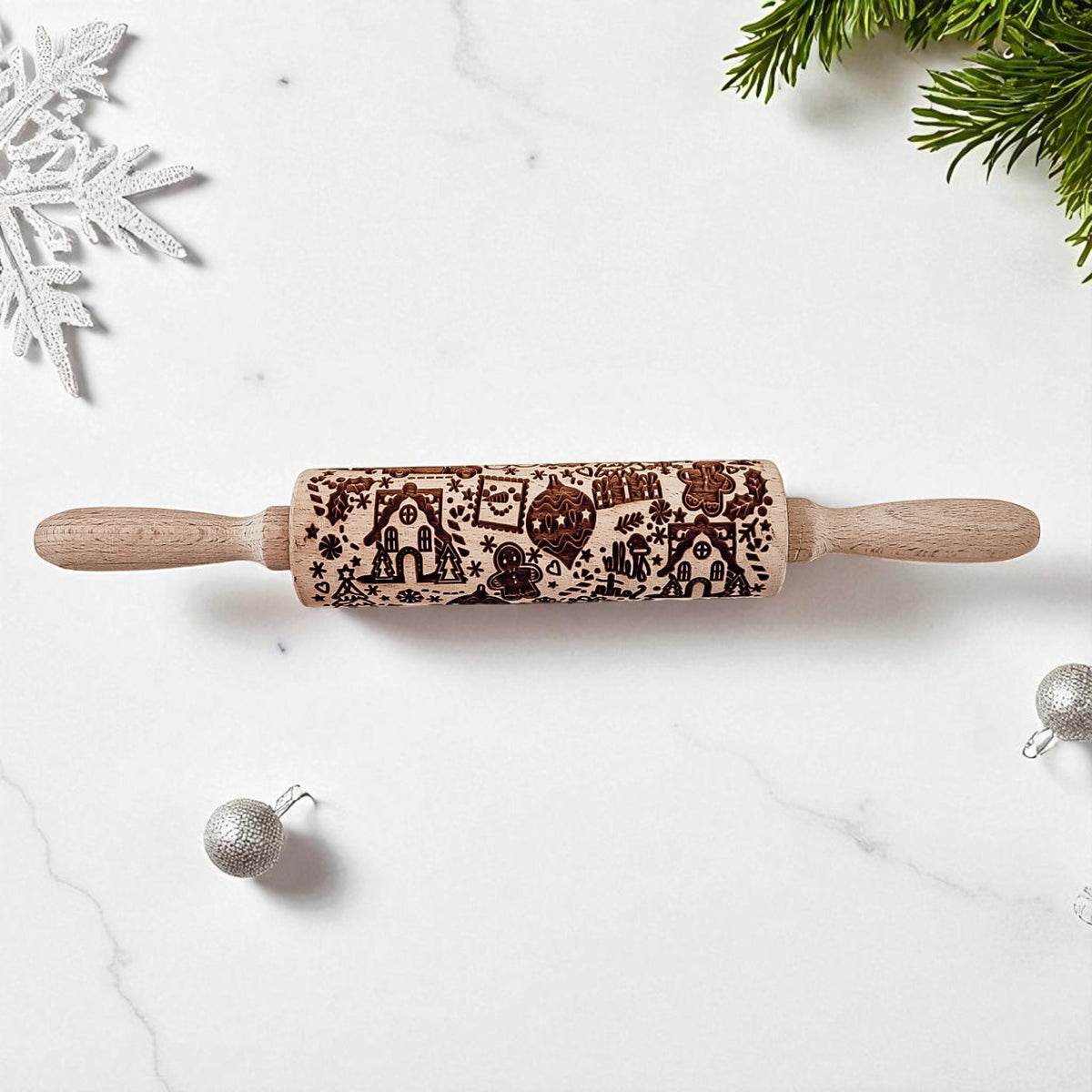 Wood rolling pin with festive gingerbread and house icon pattern on the barrel