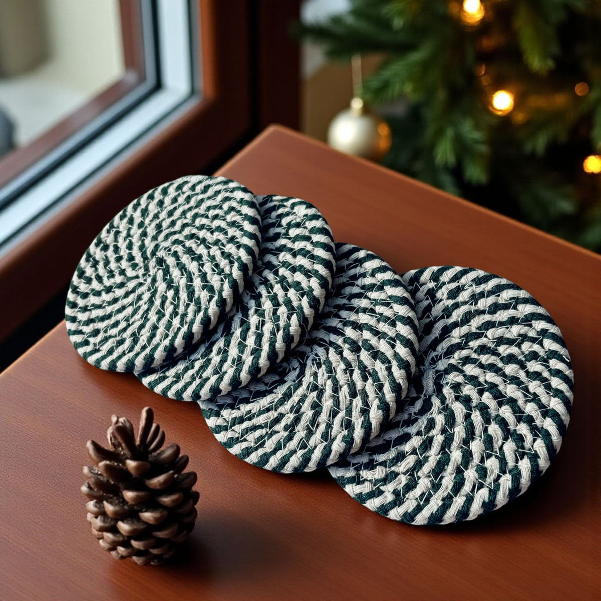 Striped braided coasters, teal and white with navy pattern, on tabletop