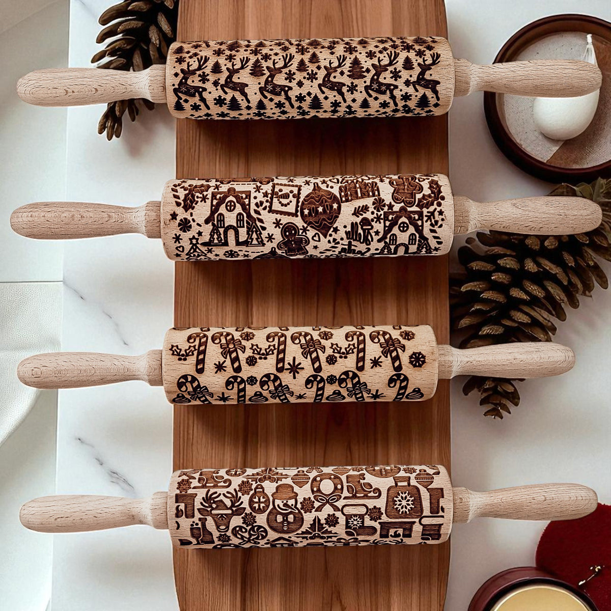 Multiple wooden rolling pins lined up with different holiday patterns and carved handles
