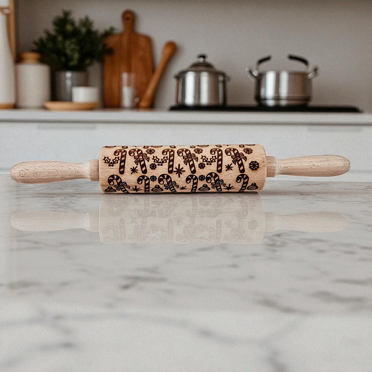 Christmas rolling pin set with carved holiday pattern and light wood handles.