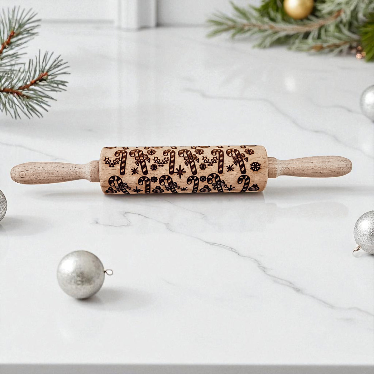 Christmas rolling pin with embossed holiday symbols on a light wood barrel