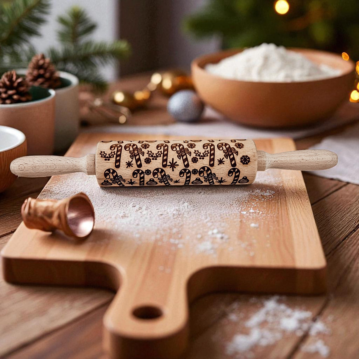 Christmas rolling pin with dark holiday icons and light wood handles on a board.