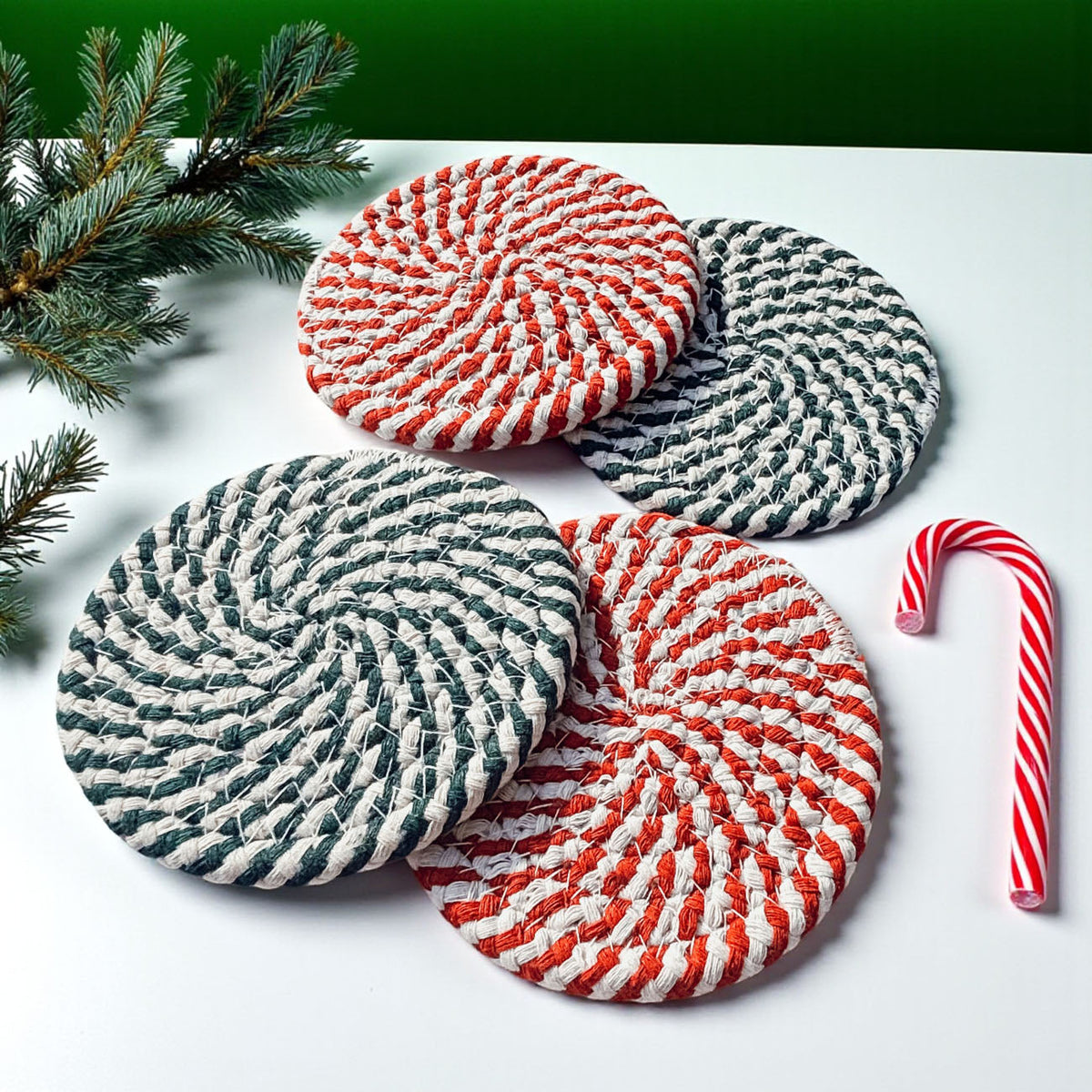 Four round woven coasters in red-white and navy-white striped designs