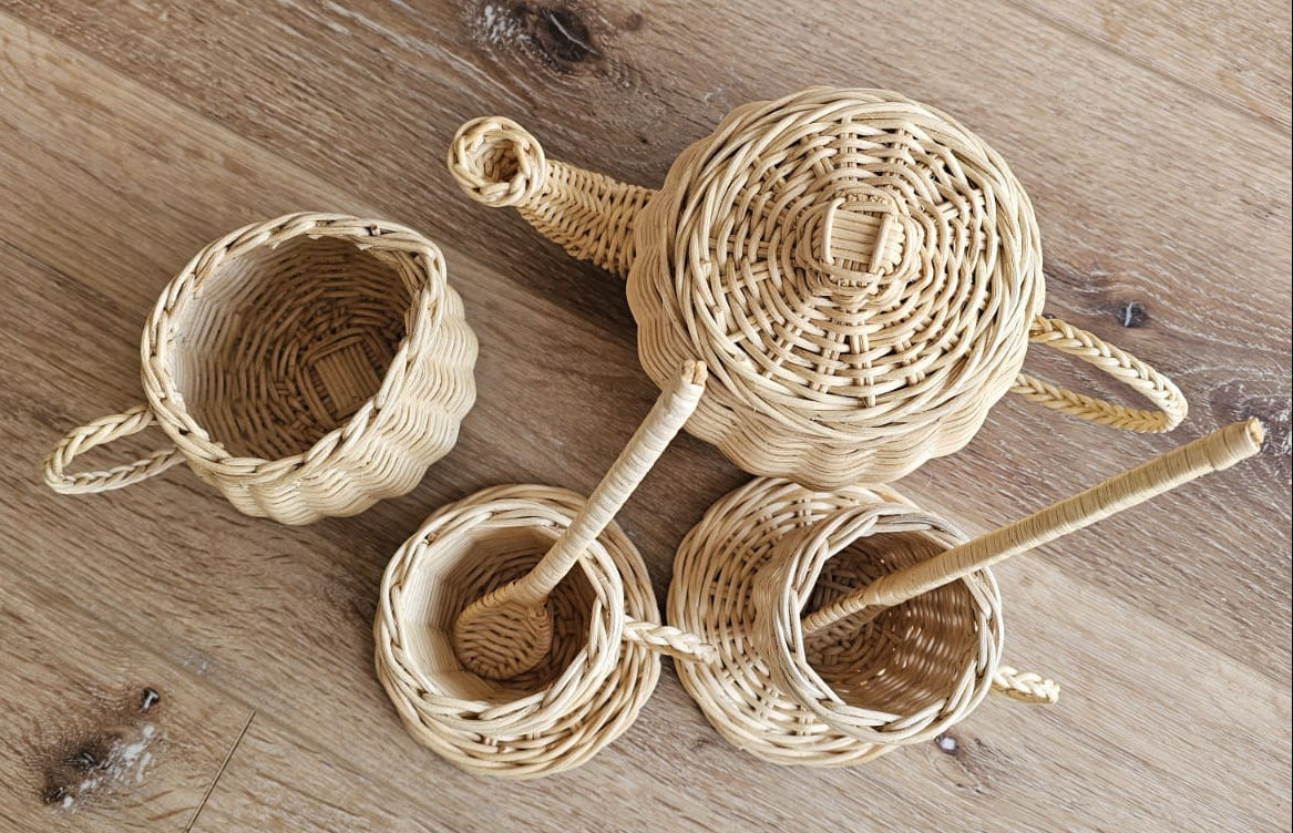 Natural wicker tea set with lidded teapot, cups, and woven spoons