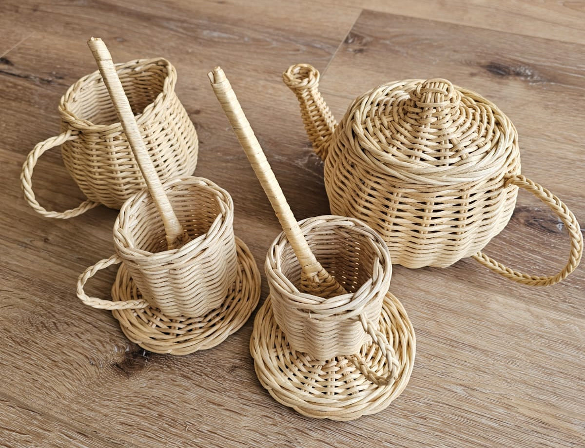 Natural wicker tea set with lidded teapot, three cups, saucers and stirrers