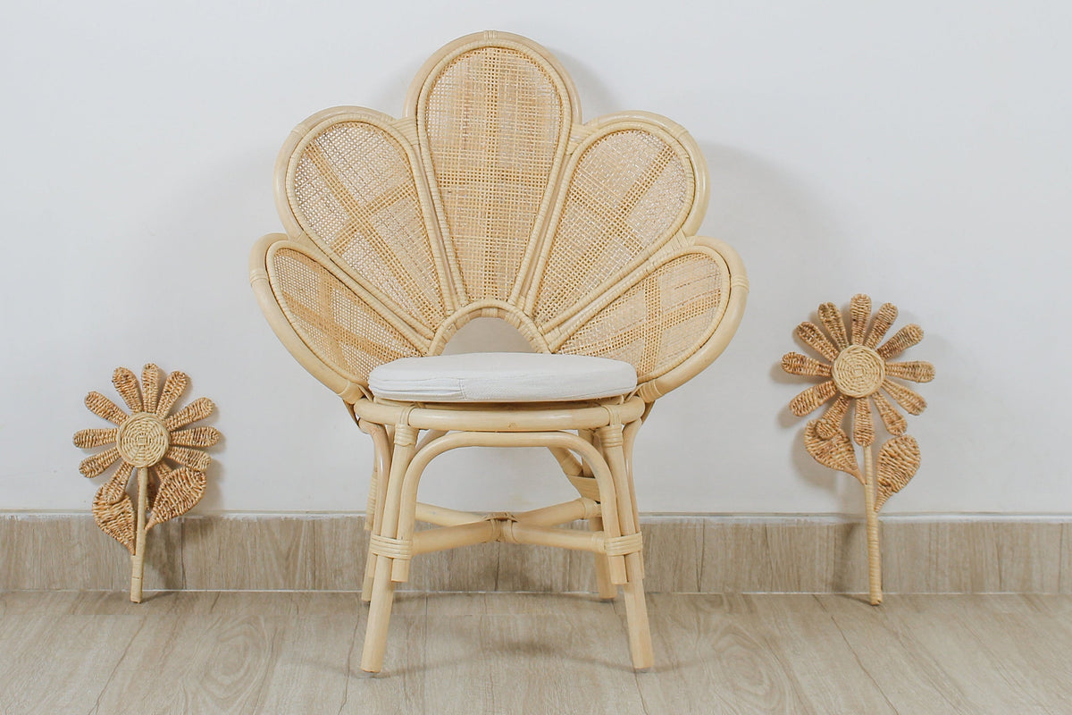Woven rattan flower stems displayed beside a rattan chair