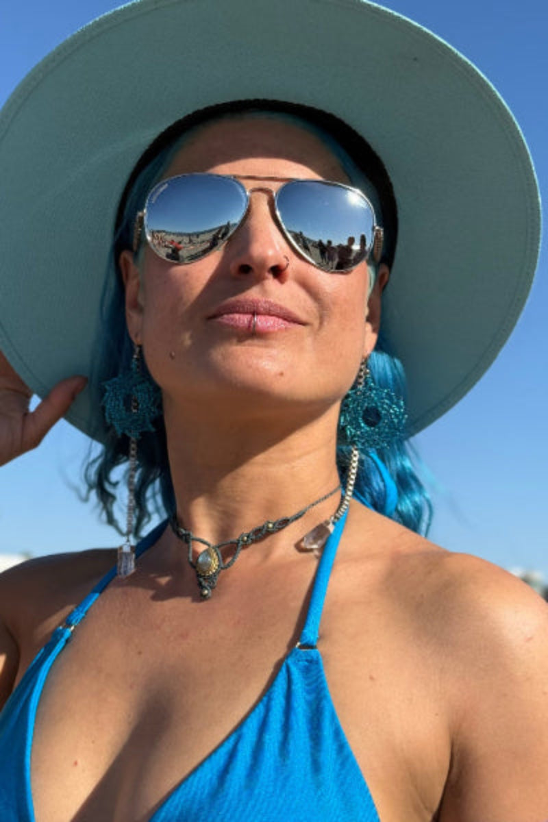 Crystal pendant necklace with cat-eye sunglasses worn together on a model