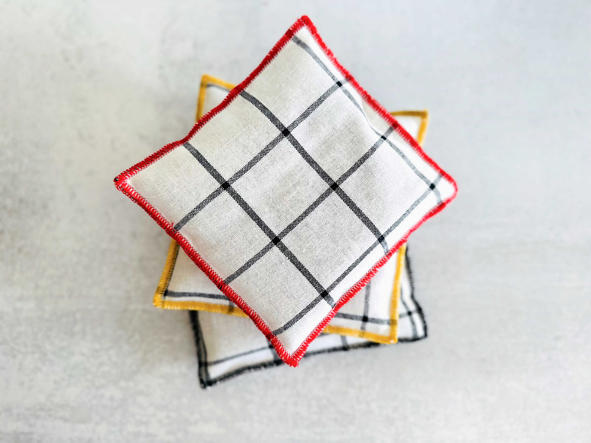 Windowpane linen lavender sachet, folded square with red trim and black grid pattern