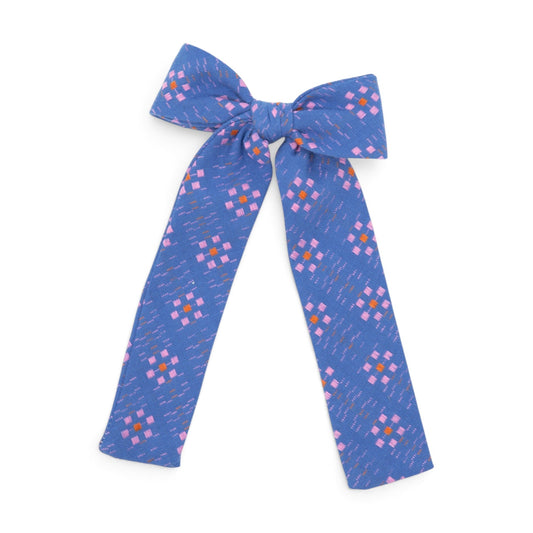 Blue geometric-pattern fabric hair bow with knotted center and long ribbon tails