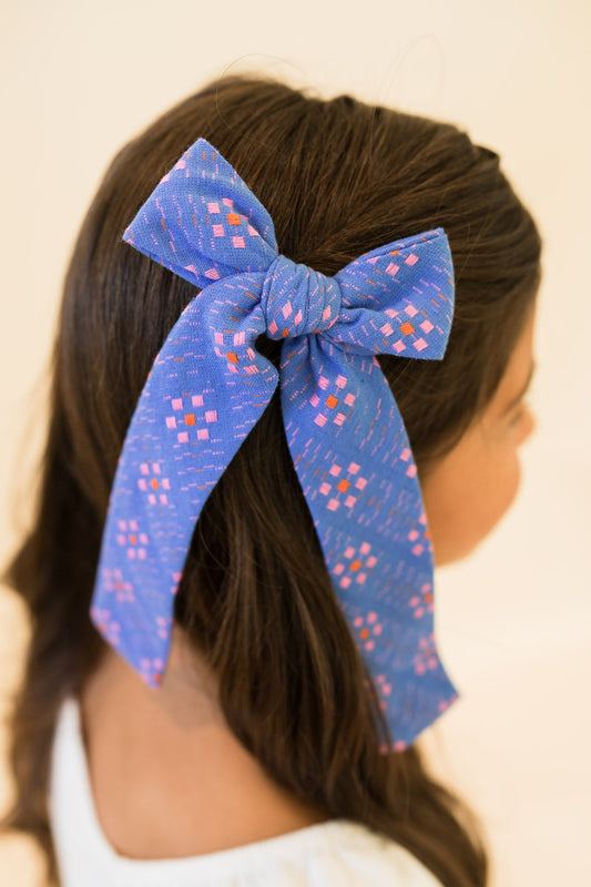 Blue geometric hair bow with tied knot and long ribbon ends