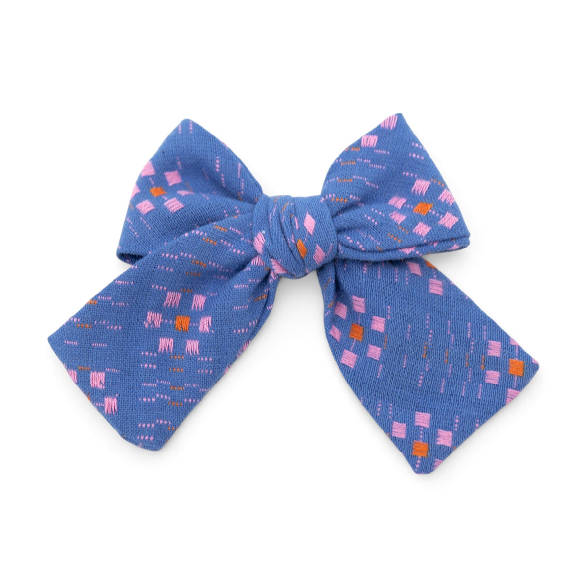 Petite hair bow with blue fabric and pink, orange geometric pattern
