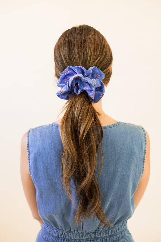 Blue patterned hair scrunchie bow on a ponytail, viewed from behind
