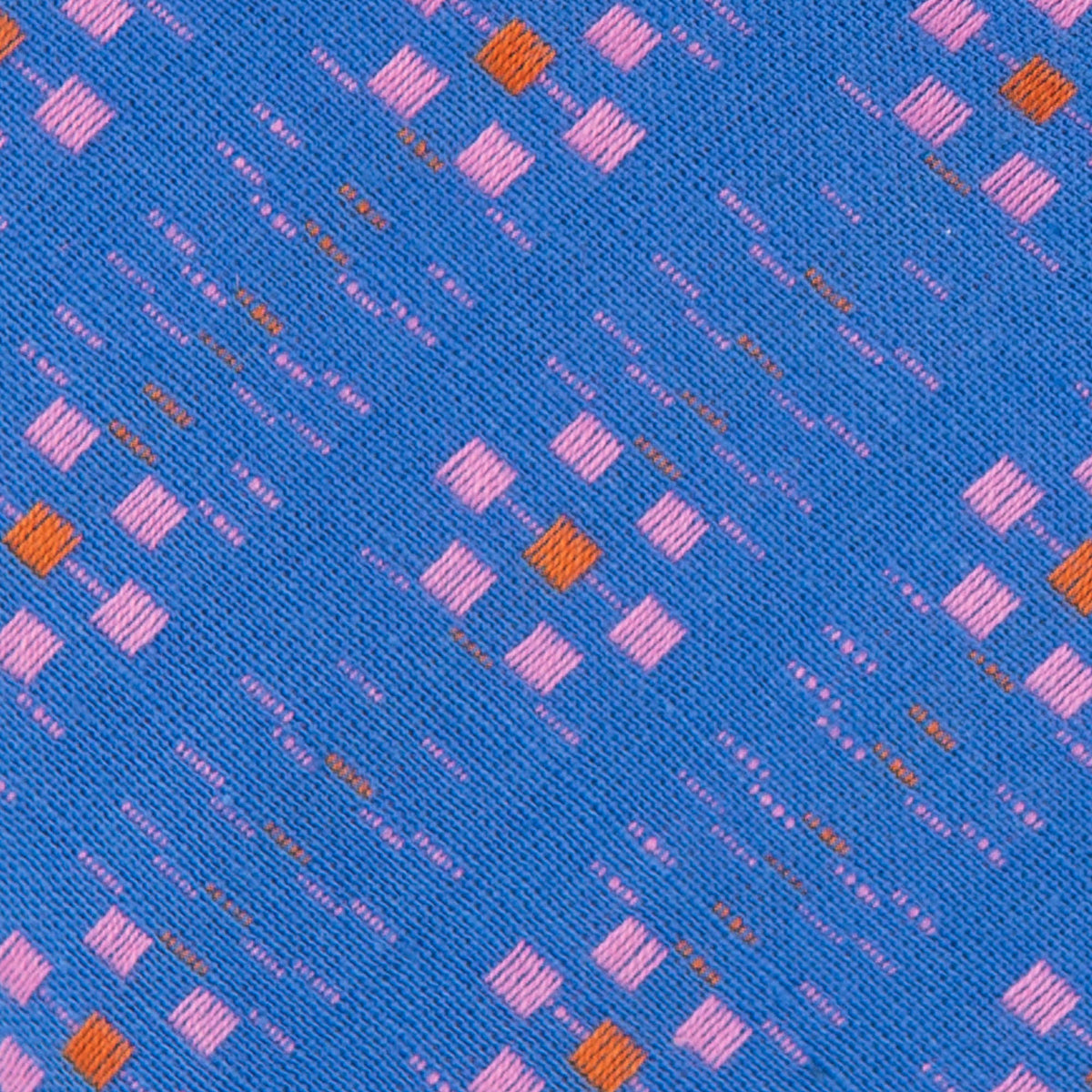 Close-up of blue fabric with small pink and orange square pattern