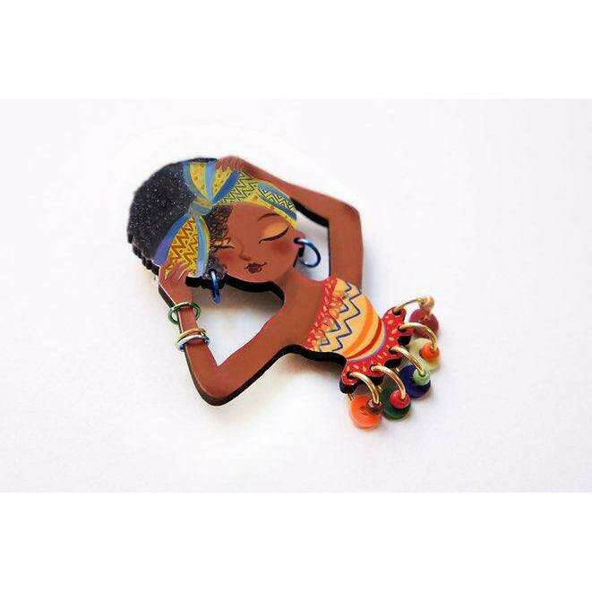 African woman brooch with red dress, blue head wrap, and hanging bead charms
