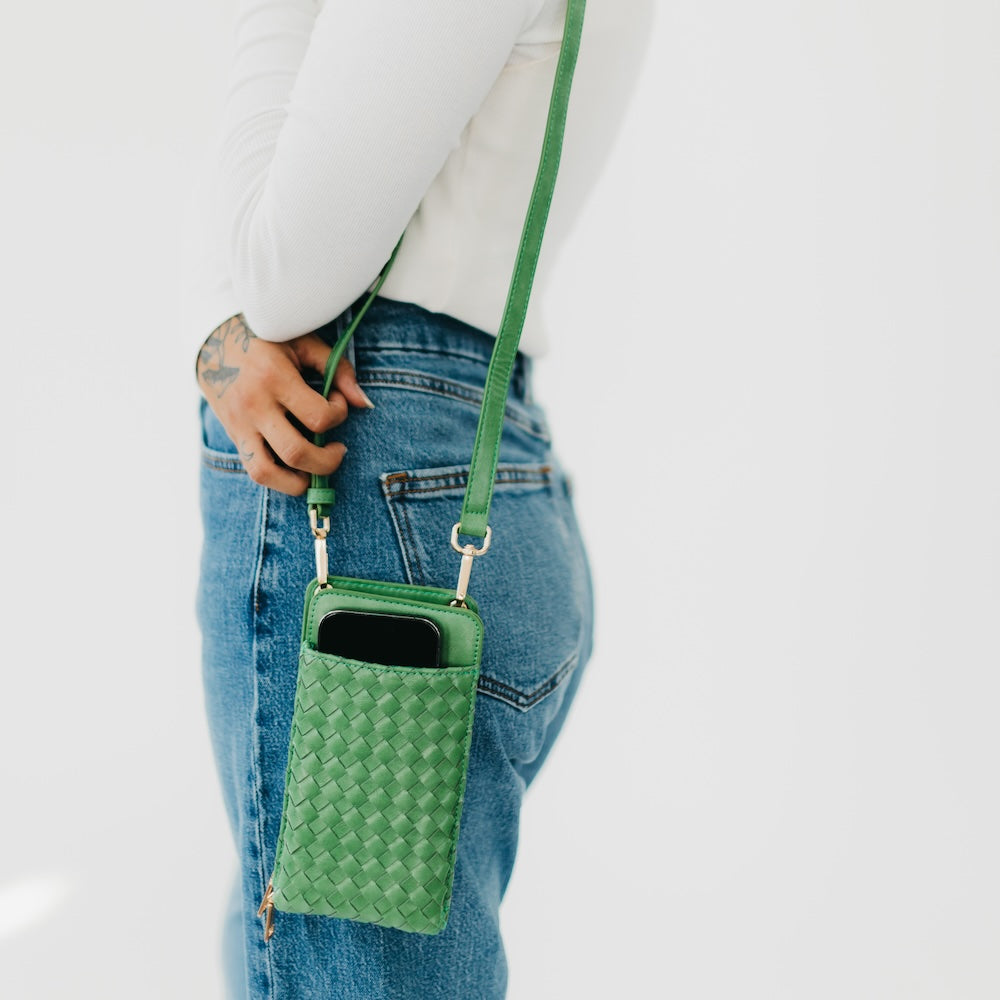 Woven phone bag in green with crossbody strap and top zipper pocket