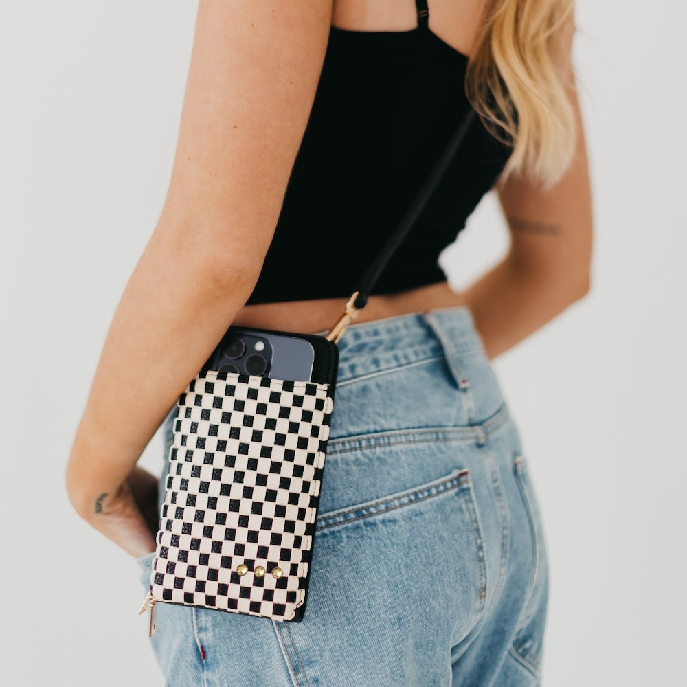 Woven double-duty phone bag with black and white checkered front and gold studs