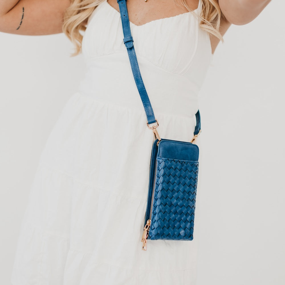Woven double-duty phone bag with teal woven front and adjustable crossbody strap