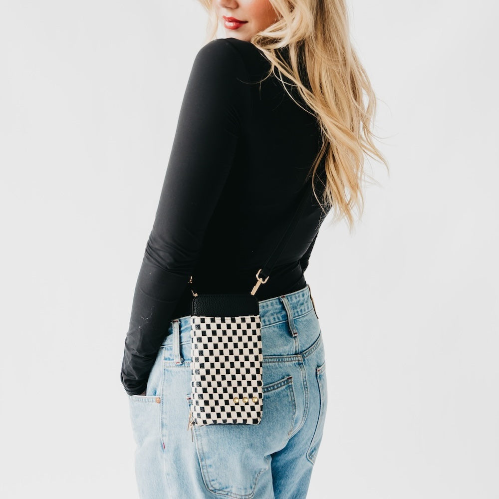 Woven double-duty phone bag with black and white checkered front and black strap