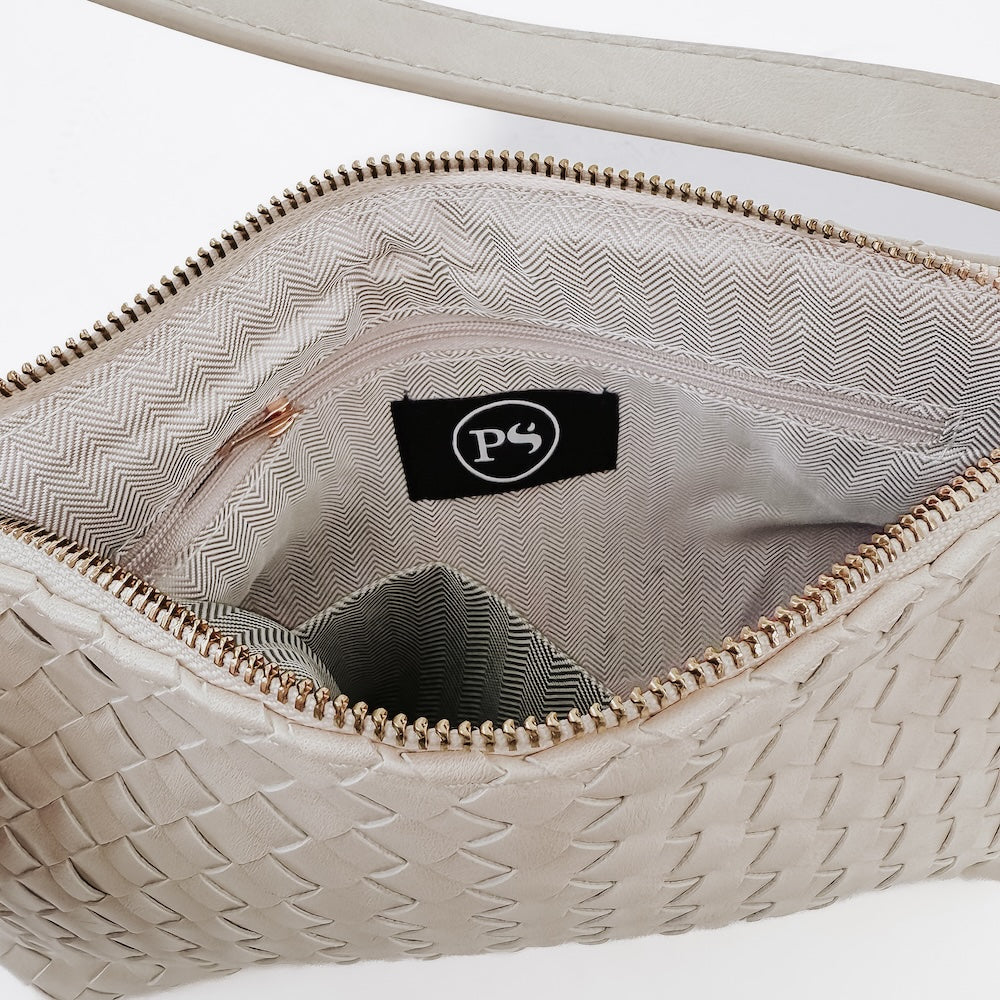 Cream woven hobo bag interior with zigzag lining and fabric logo patch