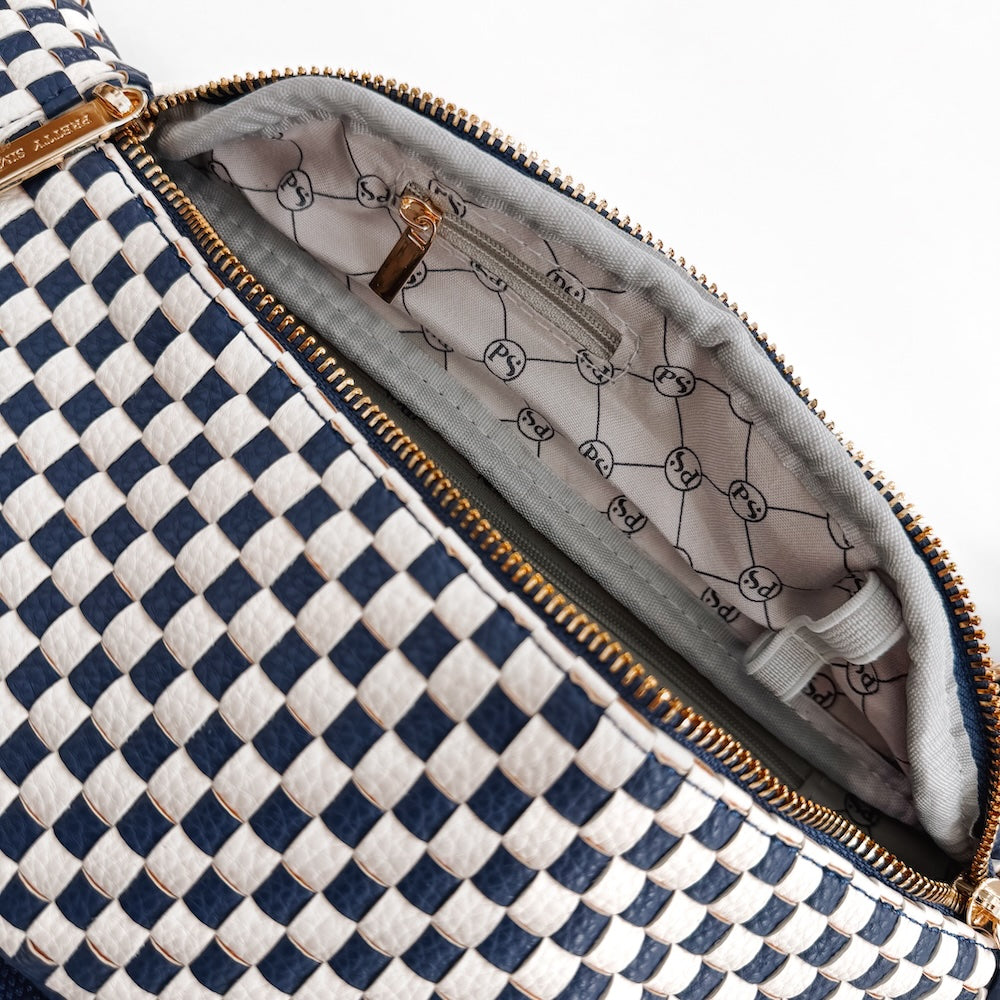 Woven bum bag interior lining with navy-and-white check exterior and gold zipper trim.