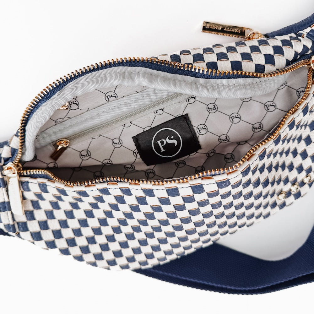 Woven bum bag open view showing logo patch and navy-and-white check pattern with zipper.