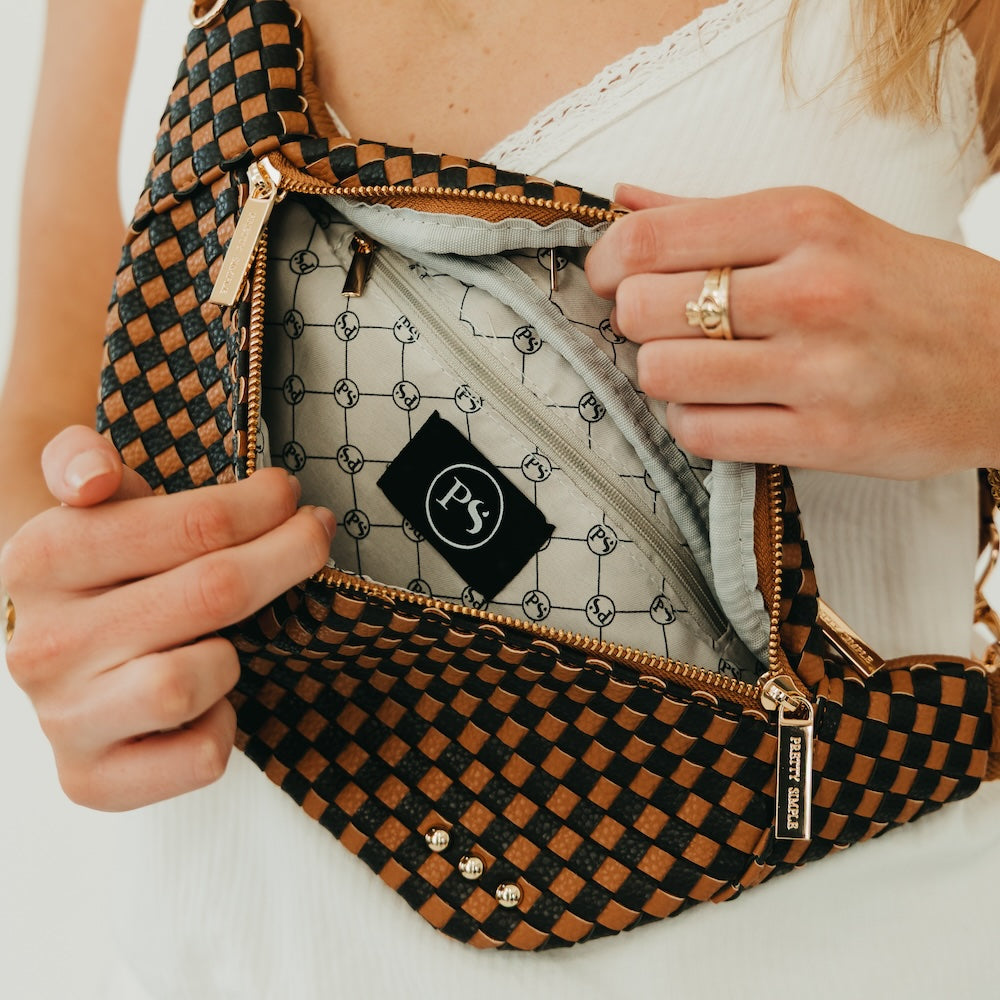 Woven bum bag with black-and-brown check pattern; open interior pocket and zipper pull.