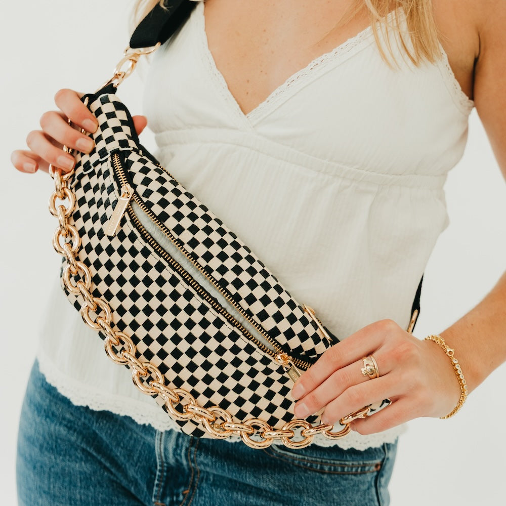 Woven bum bag with black-and-cream check pattern, gold chain detail, front zipper.