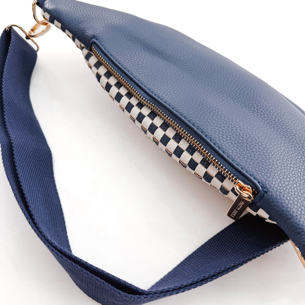 Woven navy bum bag with gold zipper and black-and-white checkered lining
