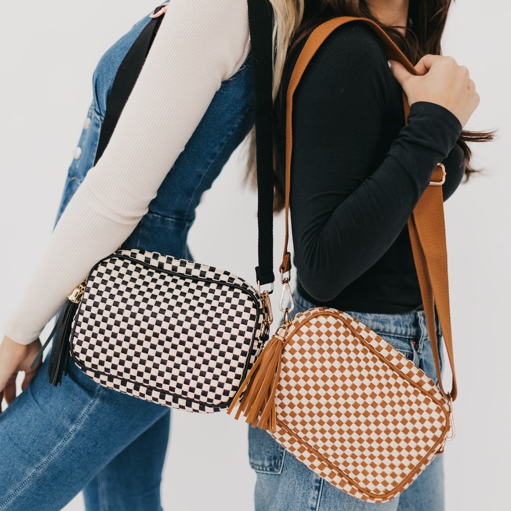Two woven camera crossbody bags: black-and-white check and tan-and-brown check.