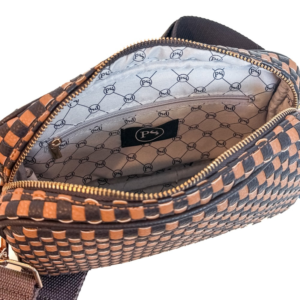 Woven camera crossbody bag interior with monogram pattern lining and zipper
