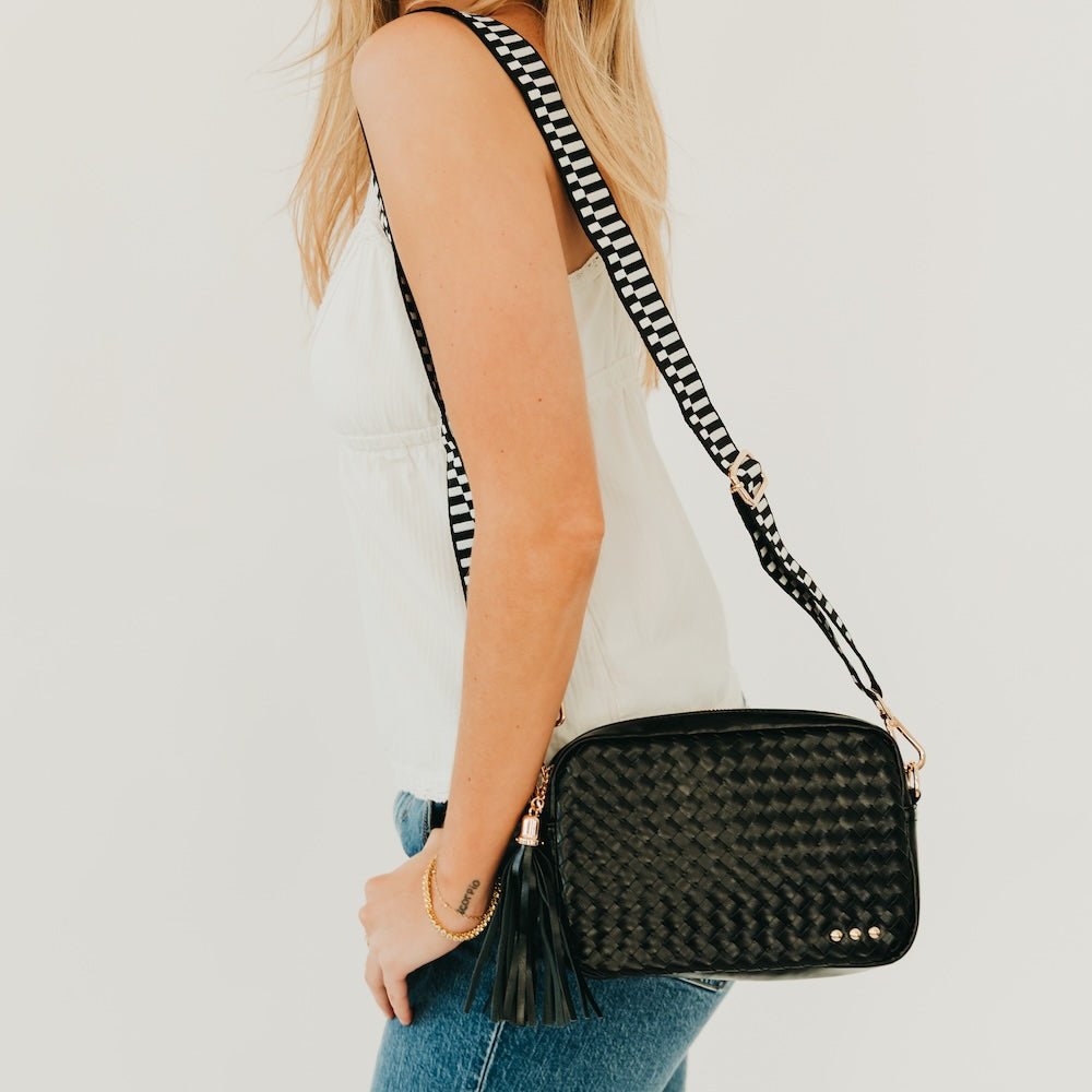 Woven mini camera crossbody bag in dark green with short fringe tassel and gold studs.