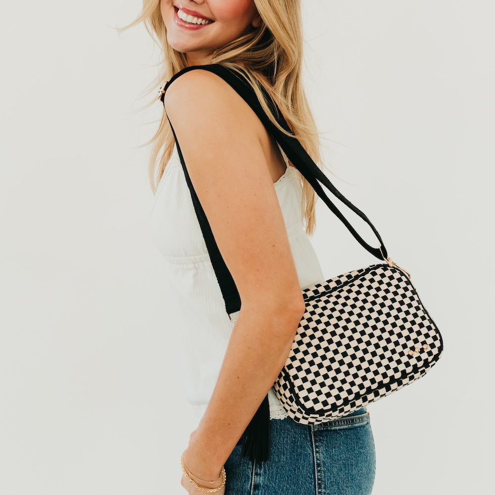 Woven willow camera crossbody bag with black-and-cream check weave, short tassel strap