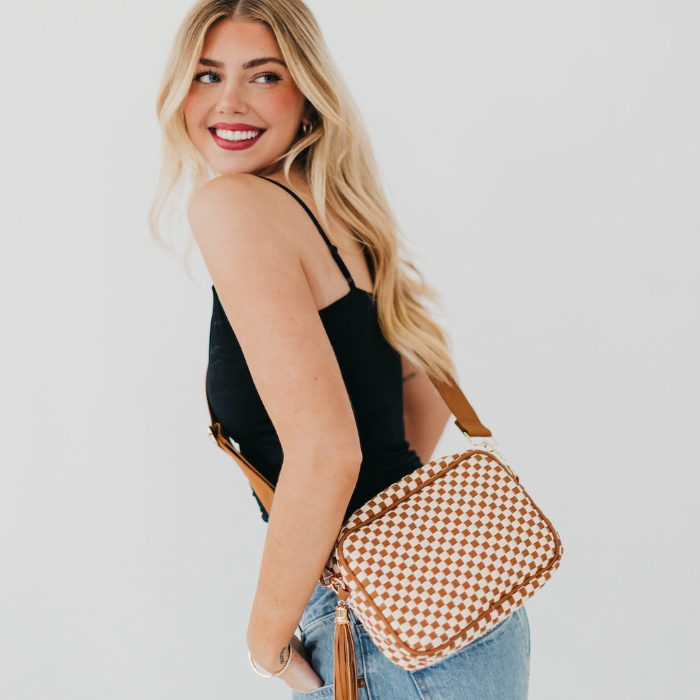 Brown checkered woven camera crossbody bag with tassel and adjustable crossbody strap