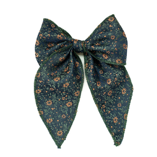 Dark green floral hair bow with layered fabric tails and center knot