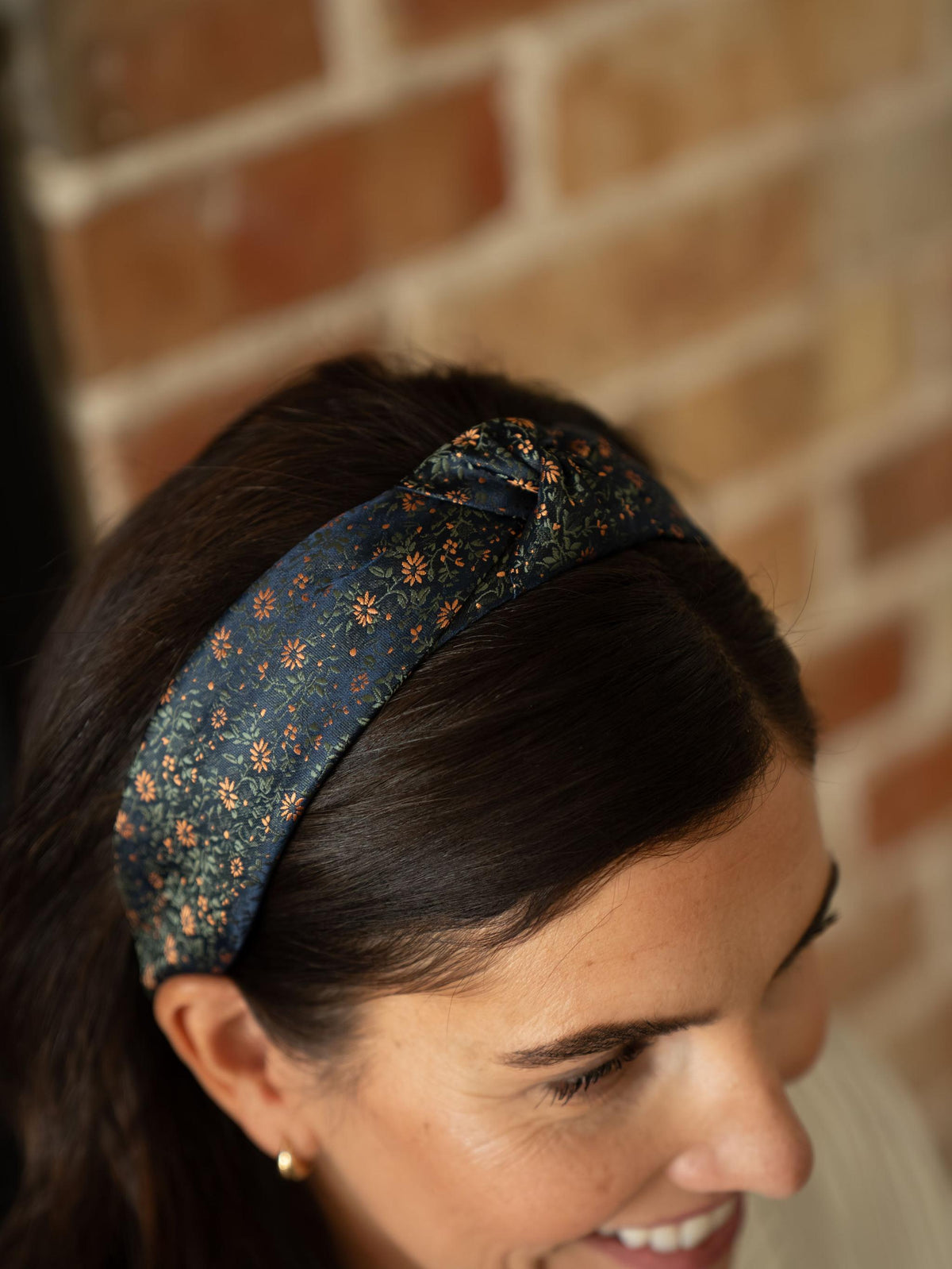 Knotted floral headband in dark teal with orange pattern