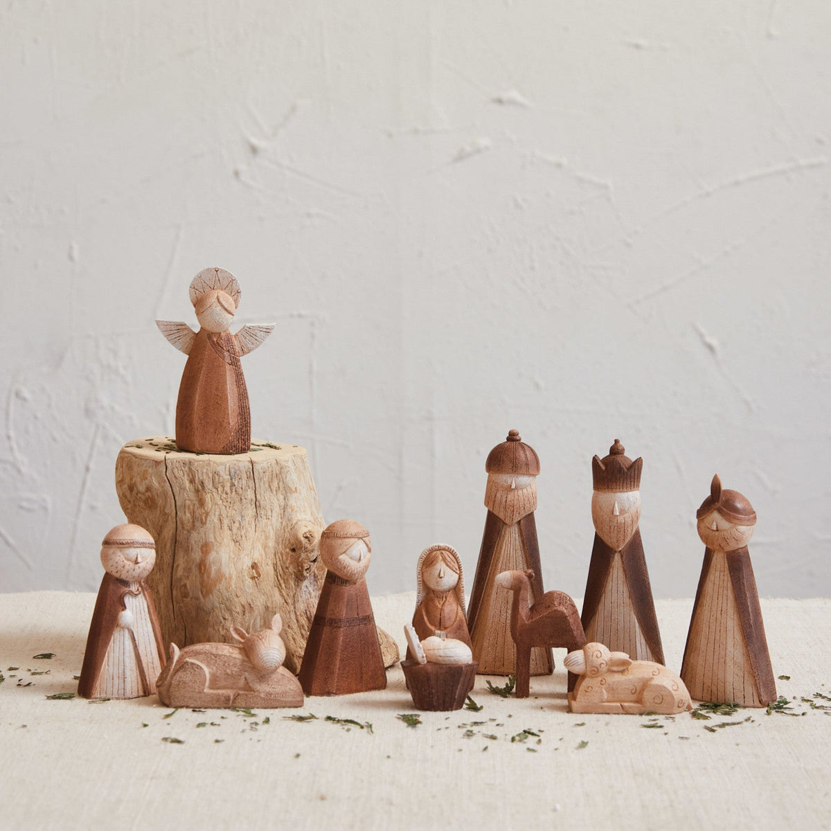 Wood-finish resin nativity set with angel, figures, animals, and a manger