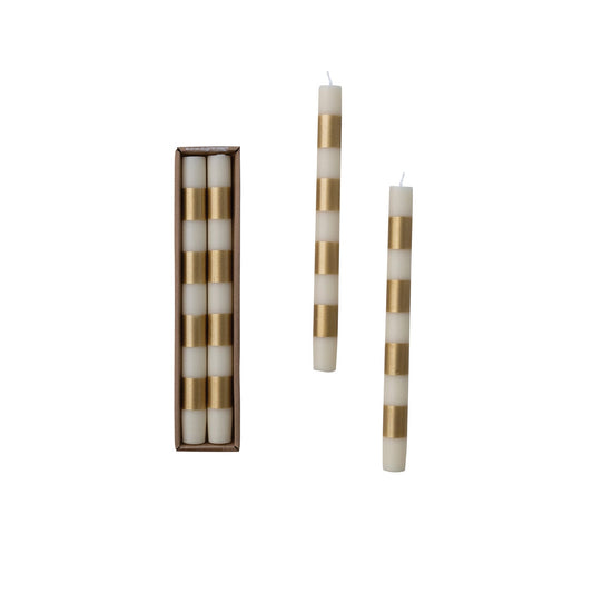 Two cream taper candles with gold bands, packed in a rectangular gift box