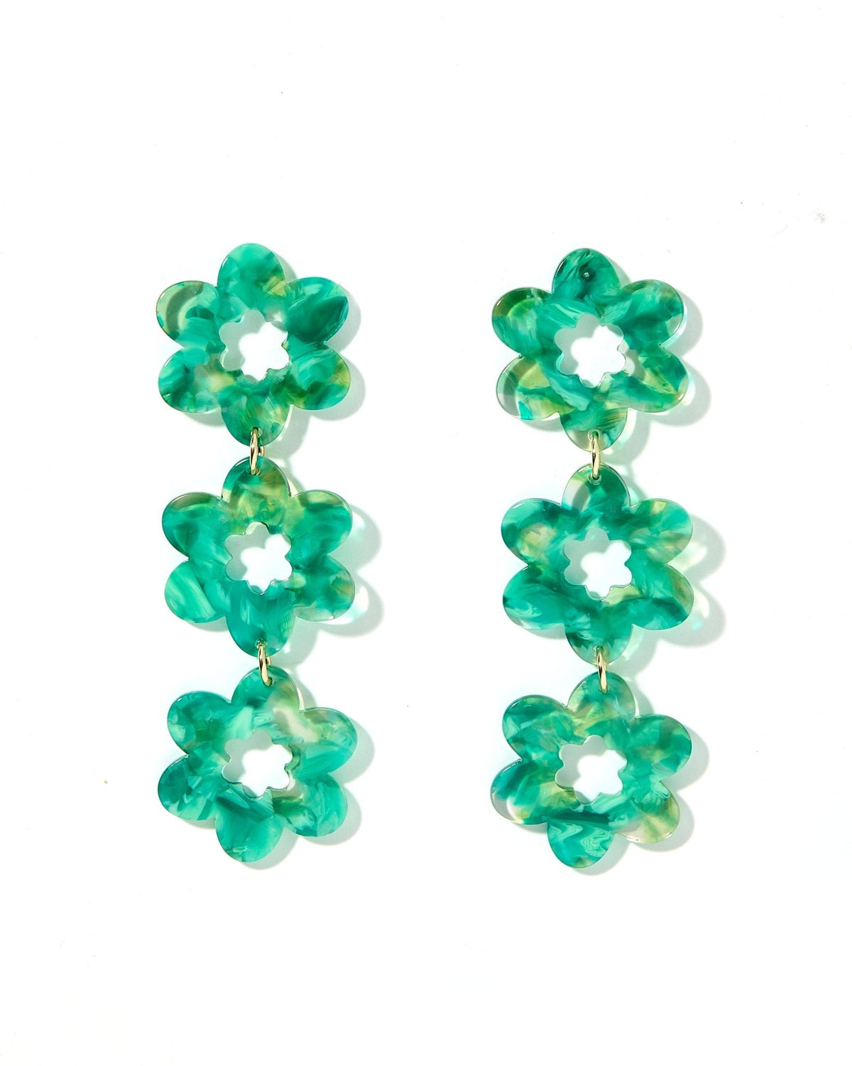 Green clover dangle earrings with white centers, three stacked blossoms